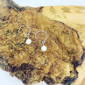 Single pearl drop earrings.